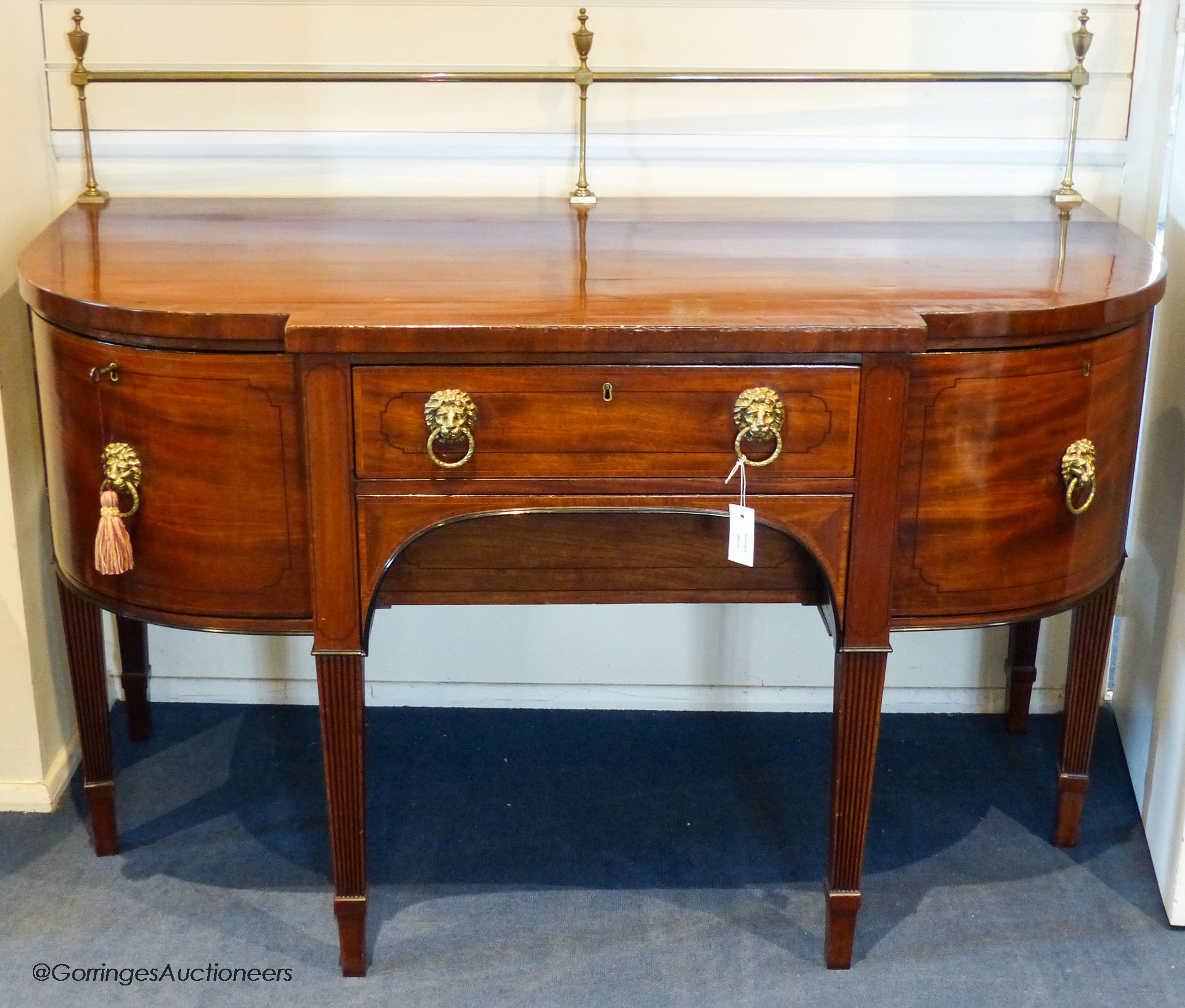 A George III mahogany bow-breakront sideboard, 152cm long, 116.5 cm high to top brass rail, 76 cm deep